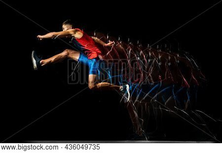 Full-length Portrait Of Young Man, Professional Track Athlete, Runner In A Jump, Training Isolated O