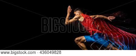 Cropped Portrait Of Young Athletic Man, Professional Runner Training Isolated Over Black Background.