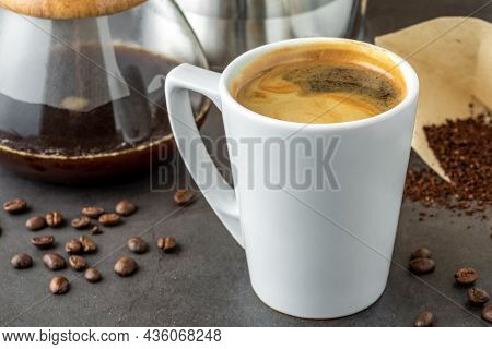 A Cup Of Coffee And Third Generation Pour Over Coffee Brewing Equipment On Stone Floor