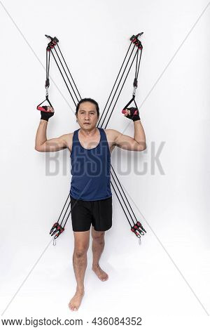 Asian Handsome Man Doing Exercise By Focusing On Tightening The Upper Arm Muscles. By Puling The Rop