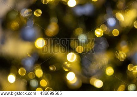 Defocused Christmas Tree Garland Illumination. Blurred Sparkling Fairy Background. Silver And Gold L