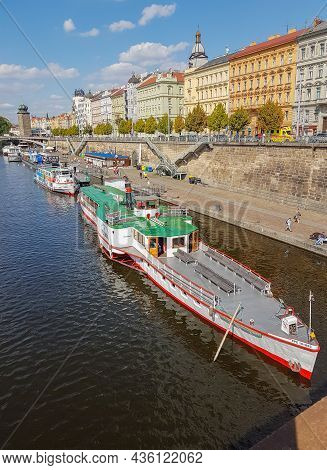 Prague Czech Republic - August 28 2017; Tourist River Boats Moored Along Vltava River Below Block Wa