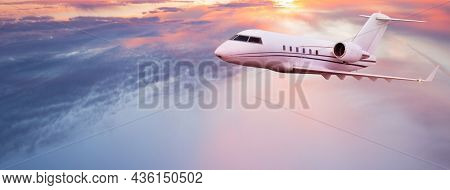 Private jetplane flying above dramatic clouds