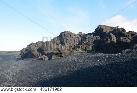 Iceland With A Black Sand Beach And Lava Rock Formations.