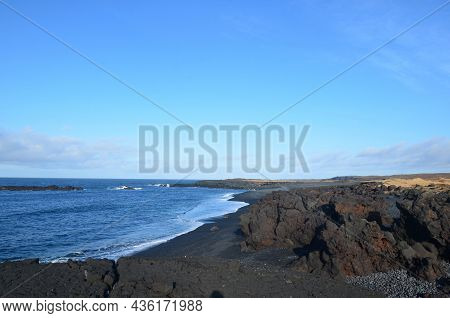 Scenic Ocean Waters And Black Sand Beach In Iceland.