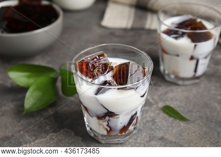 Glasses Of Milk With Delicious Grass Jelly On Grey Table, Closeup