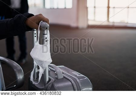 Medical Facemask On Suitcase Luggage When Delayed Flight. New Normal For Daily Life And Waiting In T