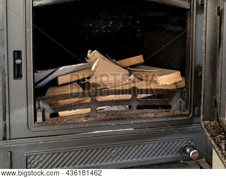 Unlighted Firewood In A Stove Of A Modern Cast Iron Fire Place, Prepared To Be Burn Up For Heating A