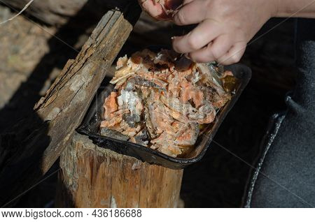 Cooking Traditional Uha. Woman Shook Her Hands Over Pieces Of Cooked Fish. Separates Fish Bones. Stu