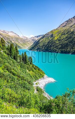 Vivid Blue Mountain Lake In Summer Alps. Speicher Zillergrundl Dam, Zillertal Alps, Austria