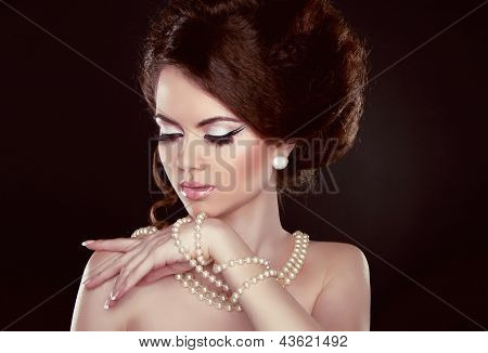 Beautiful Pretty Woman With Pearls On Her Neck Isolated On Dark Background