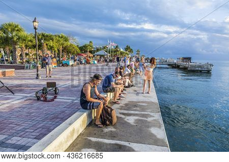 Key West, Usa - August 26, 2014: People Enjoy The Sunset Point At Mallory Square In Key West, Usa. T