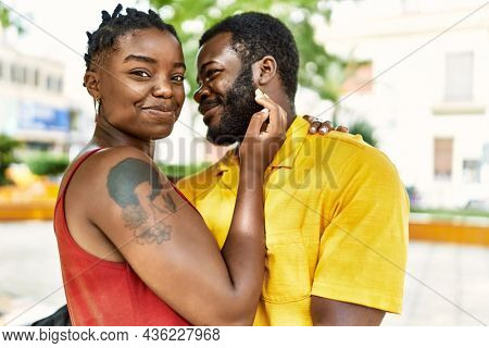 Young afircan american couple smiling happy and hugging at the city.