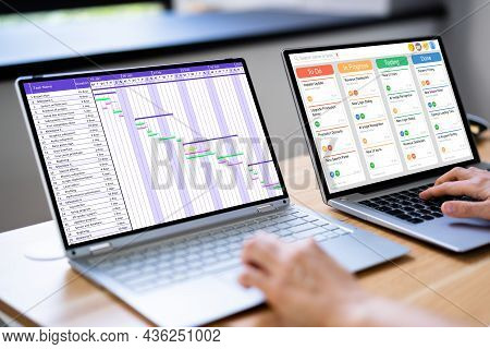 Businesswoman Marking Schedule On Calendar With Gantt Chart On Laptop Screen Modern