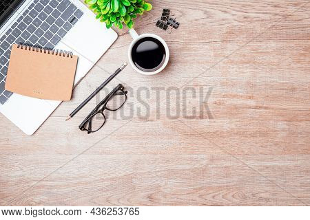Work From Home. Desk Office With Laptop, Blank Notepad, Coffee Cup And Pen On Wood Table. Flat Lay T