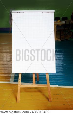 White Flattery In A Cage Stands On An Easel Or Wooden Stand. This Is A Manual For Recording Text Or 
