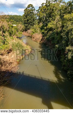Cadeia River With Bridge Shadow And Forest Around In Sao Jose Do Hortencio, Rio Grande Do Sul, Brazi