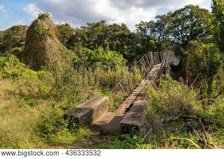 Wood And Iron Bridge Over Cadeia River With Forest Around