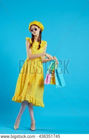 Cheerful Woman In A Yellow Hat Shopaholic Fashion Style Studio Model
