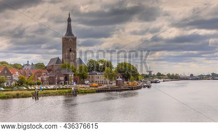 City Of Hasselt On The River Ijssel In Province Of Overijssel In The Netherlands. Under Clouded Summ
