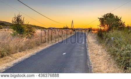 Sunrise Over Road In Highland Limestone Karst Plateau Landscape On Causse De Blandas, Occitanie, Fra