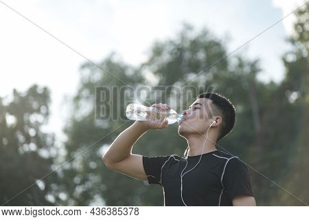 Fitness Athlete Young Man Drinking Water After Working Out Exercising At The Park.