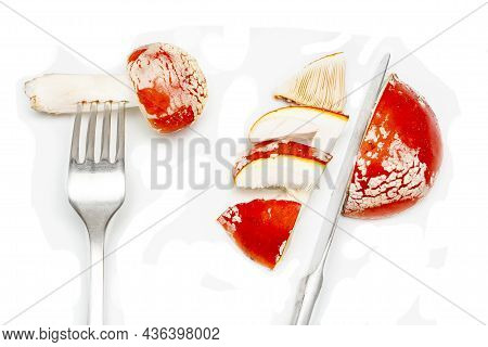 Red Fly Agaric (amanita Muscaria) On A White Background With Cutlery Fork And Knife. The Concept Of 