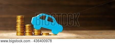 Decrease In Prices For Cars And Components. Reducing The Loan Rate. Stack Of Coins With Steps Down A