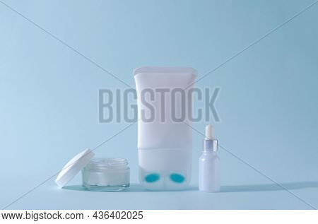 Cream For Skin Care Of The Neck And Decollete In A White Tube, Serum In A Glass White Bottle, Cream 