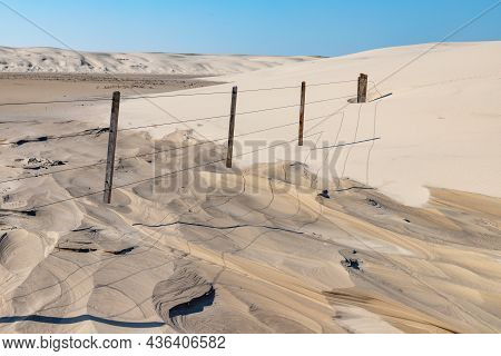 Wood And Iron Fence In Dunes
