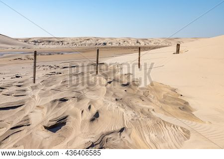 Wood And Iron Fence In Dunes