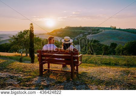 Tuscany, Crete Senesi Rural Sunset Landscape. Countryside Farm, Cypresses Trees, Greenfield, Sunligh