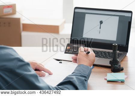 Car Service Staff Holding Credit Card For Pay For Auto Repair Parts And Use Laptop Check Part In Sto