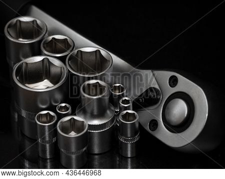 Ratchet Wrench. Set Of Stainless Steel Hex Sockets On Shiny Black Surface. Universal Professional To