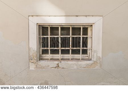Old Rusty Cellar Window With Iron Grating