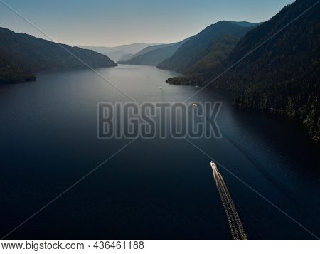 Motor Boat Moored To The Shore Of A Mountain Lake. Russia, Altai Republic, Ulagansky District, Lake 