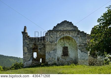 Ruins Of An Ancient Christian Temple On Background Of Blue Sky With Clouds. Old Dilapidated Church. 