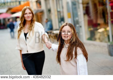 Young Mother And School Preteen Girl Making Walk In The City. Happy Family, Woman And Daughter With 