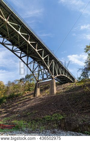 Old Arch Bridge Viewed From Beneath Showing Severe Deterioration Through Rusting Structural Supports