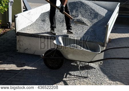 Delivery Of Gray River Pebbles, Gravel As Mulch For Flower Beds In The Garden Using A Wheel From The