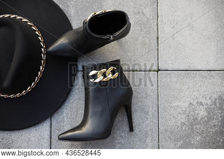 Stylish Black Leather Boots And Hat Outdoors In The Street