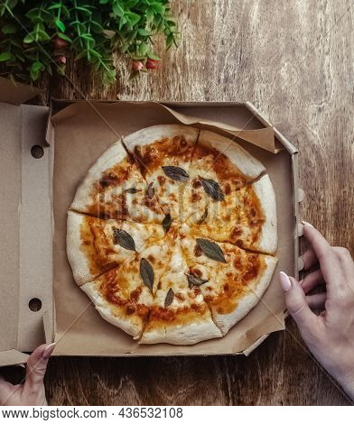 Close-up Of Margarita Pizza In A Disposable Dish. Top View Of Takeaway Food In A Fast Food Cafe. On