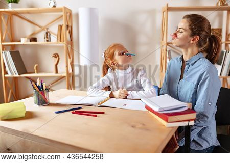Cheerful Family. Mother And Daighter Doing Homework Together, Having Fun And Making Faces