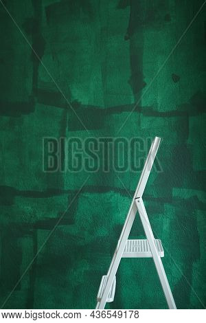 Home Improvement Concept, White Step Ladder And Green Unfinished Wall. Diy Interior Renewal Vertical