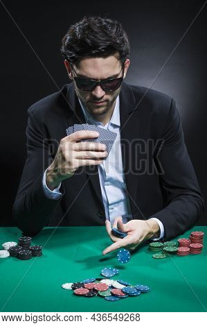 Casino Concepts. Caucasian Young Handsome Pocker Player Staking And Betting To Win At Pocker Table W