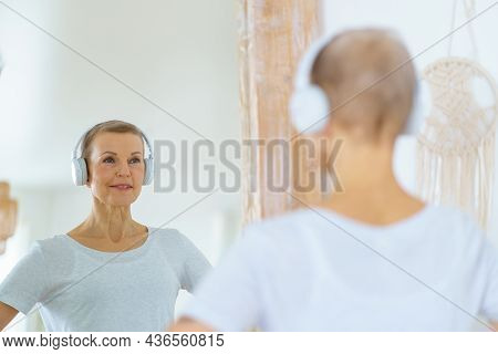 Grey Haired Senior Woman Admiring Herself In Mirror. Middle-aged Female Looks At Herself. Mature Bea