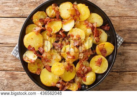 Bratkartoffeln German Cottage Fries With Bacon And Onion Close Up In The Plate On The Table. Horizon
