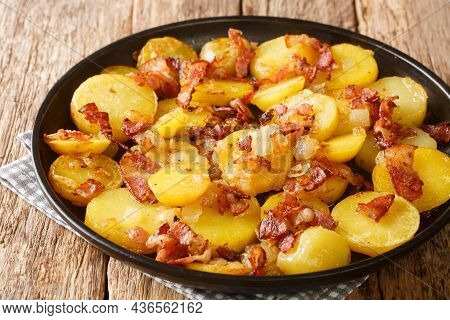 Bratkartoffeln German Cottage Fries With Bacon And Onion Close Up In The Plate On The Table. Horizon