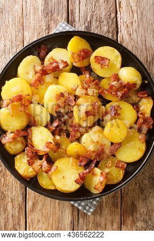 Bratkartoffeln German Cottage Potatoes With Bacon And Onion Close Up In The Plate On The Table. Vert