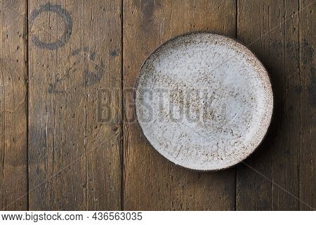 Clean Empty Ceramic Textured Plate On Dark Brown Wooden Table Background. Horizontal, Copy Space, To